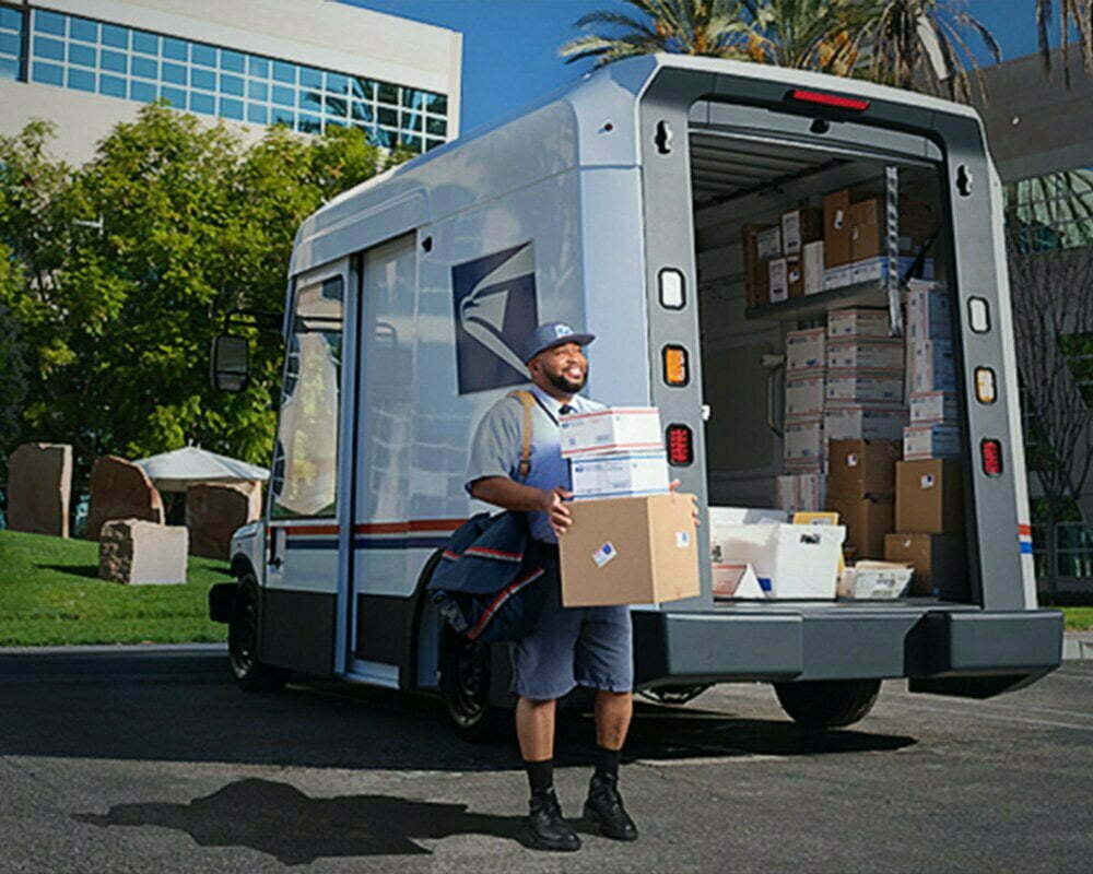 Letter carrier ready to deliver packages unloaded Letter carrier ready to deliver packages unloaded